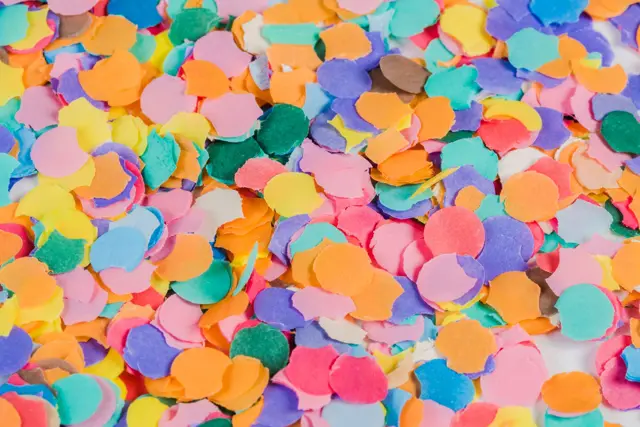 Vibrant array of colorful paper confetti scattered on a surface creating a festive look.